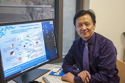 Sean Xie with his computer system for research